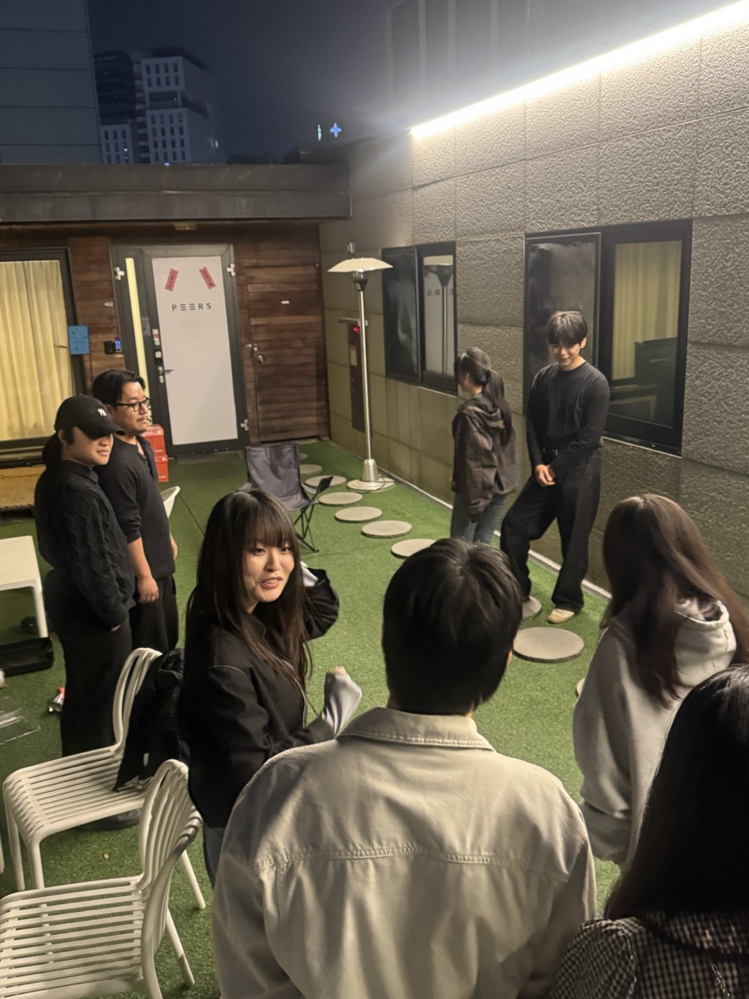 PEERS members chatting on the rooftop at night